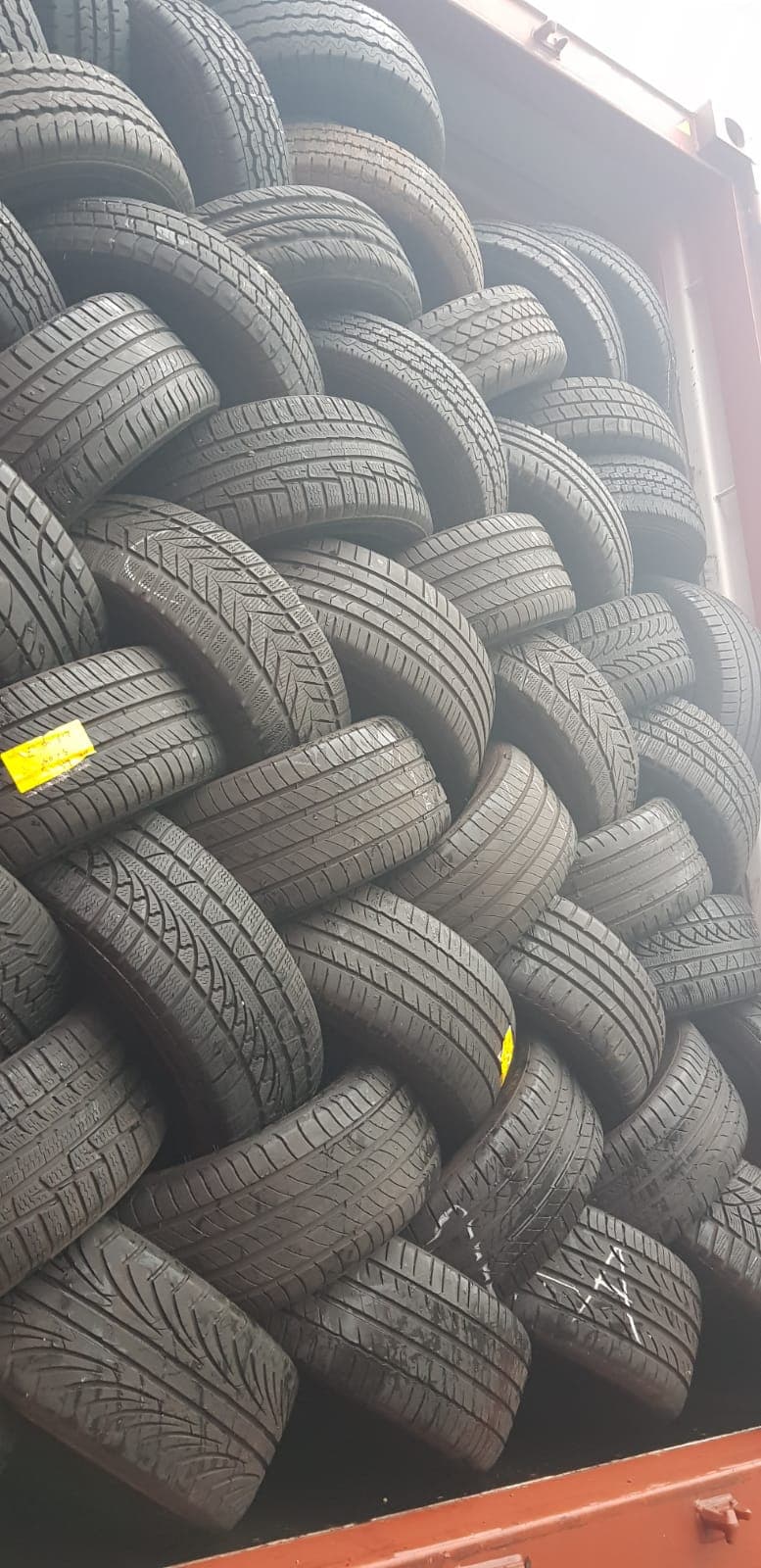 Close up of stacked tyres inside a container